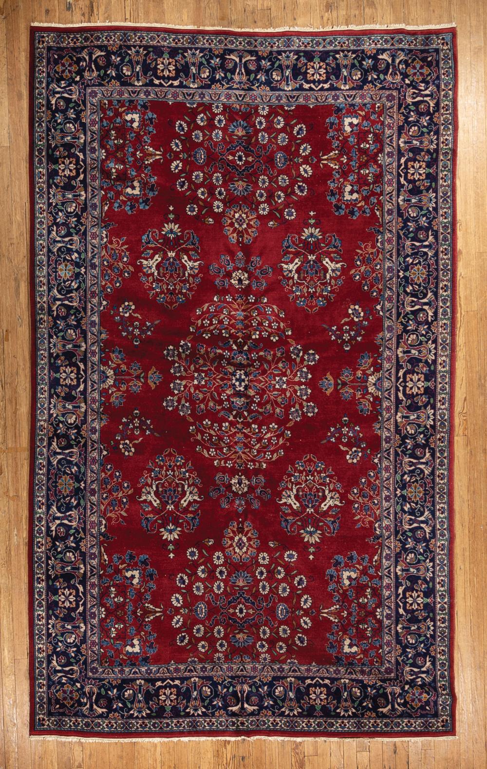 Appraisal: Persian Carpet red ground blue border foliate design ft in