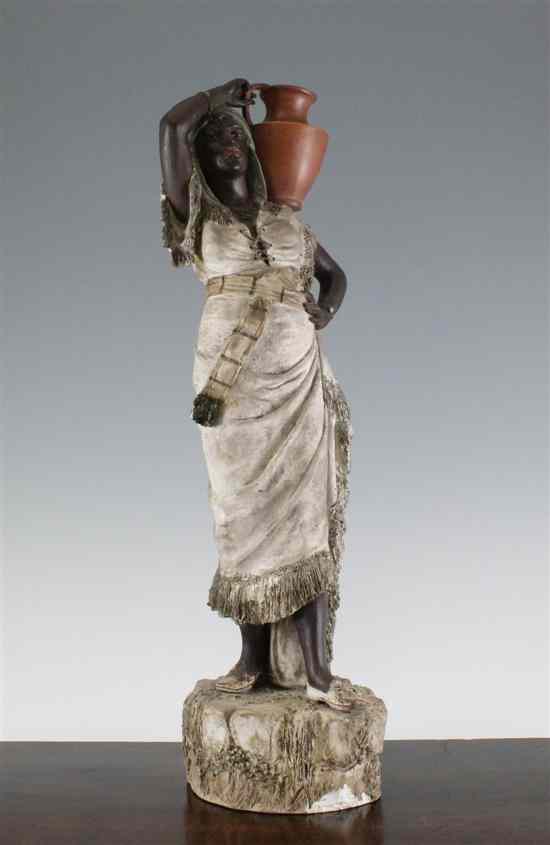 Appraisal: An Austrian cold painted pottery figure of an African woman