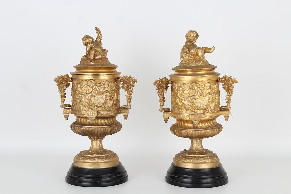 Appraisal: French Gilt Bronze Twin Handled Cherubic Urns French Gilt Bronze