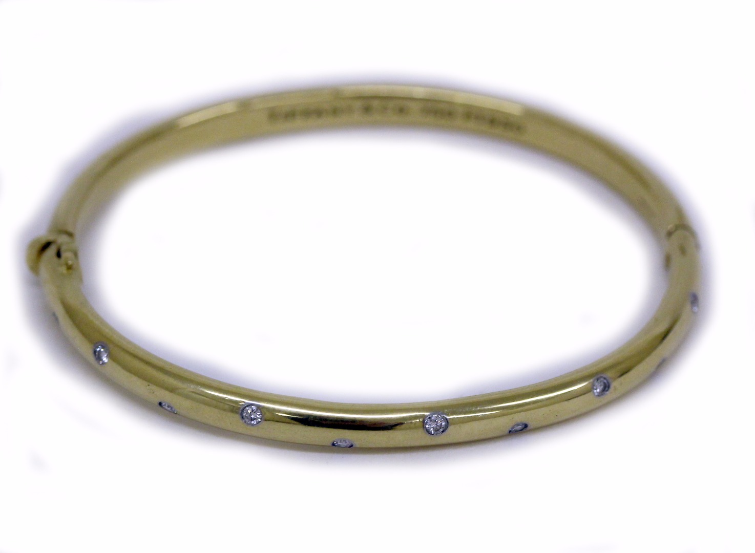 Appraisal: A yellow gold and diamond hinged bangle by Tiffany Co