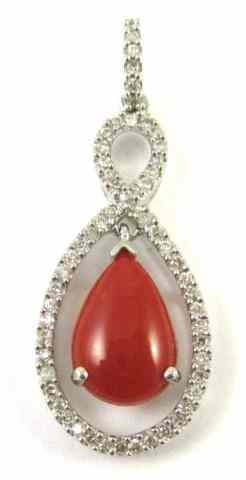 Appraisal: CORAL DIAMOND AND FOURTEEN KARAT GOLD PENDANT round-cut diamonds are