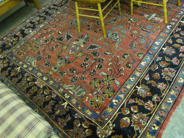 Appraisal: Room size Persian rug traditional pattern red field with blue