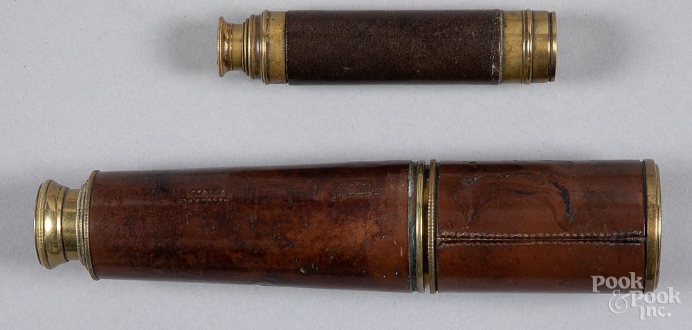 Appraisal: Two brass and leather three draw telescopes Two brass and