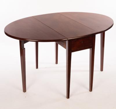 Appraisal: A George III mahogany oval two-flap table on square taper