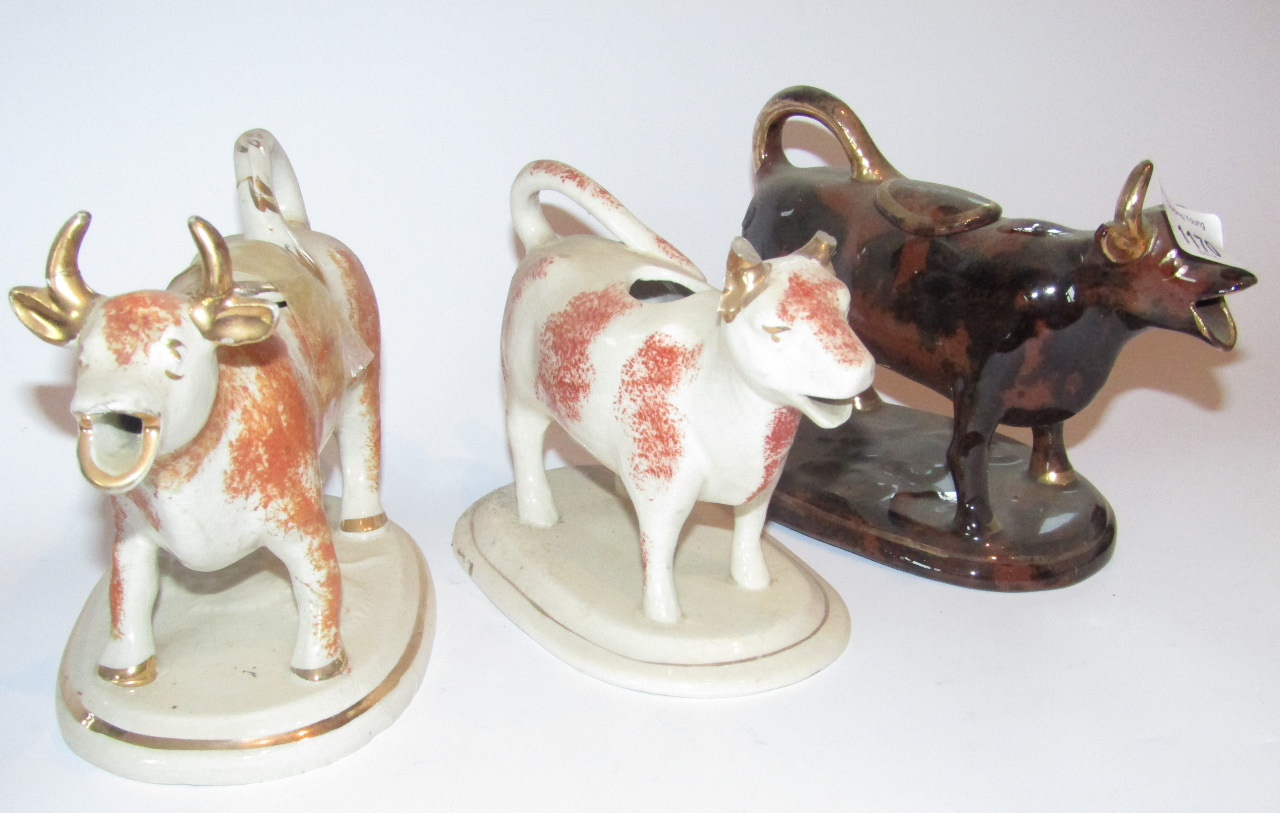 Appraisal: A mid- thC Staffordshire pottery cow creamer in sponged black