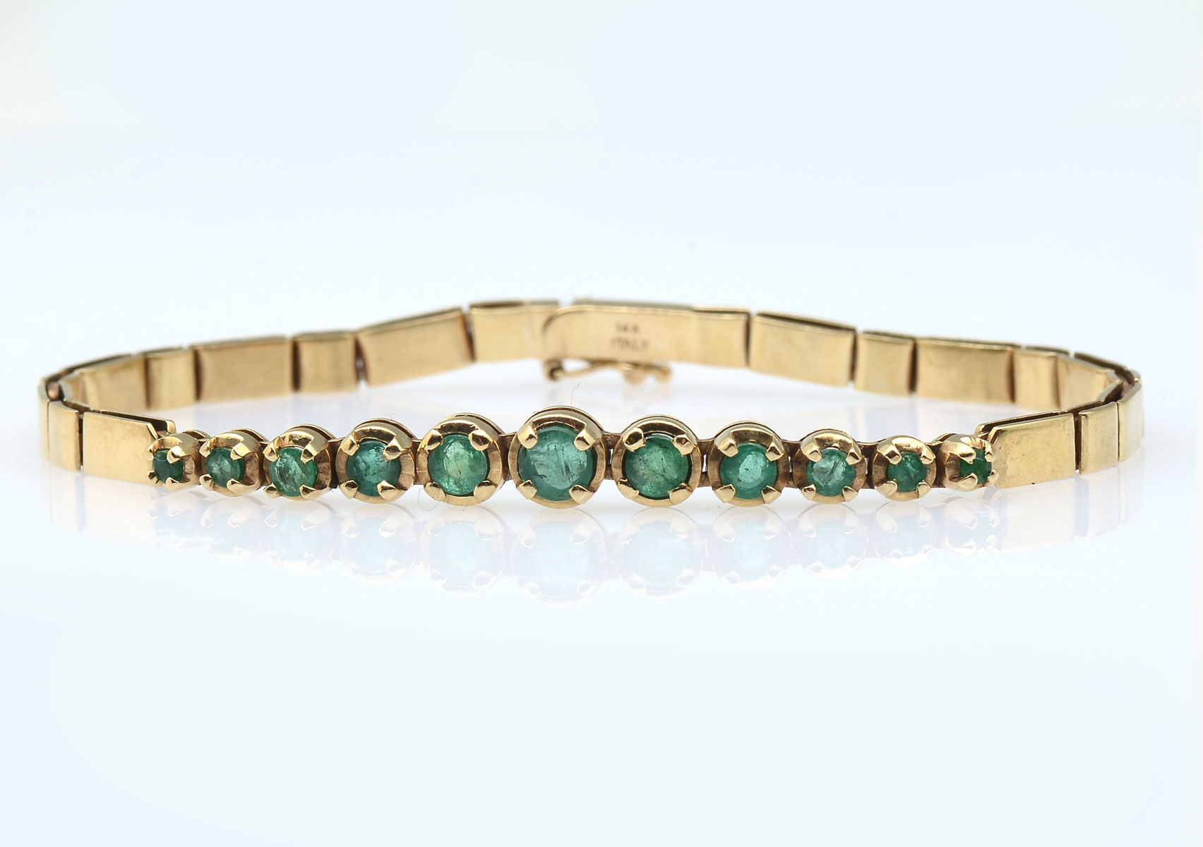 Appraisal: K CTW EMERALD BRACELET K yellow gold emerald bracelet contains