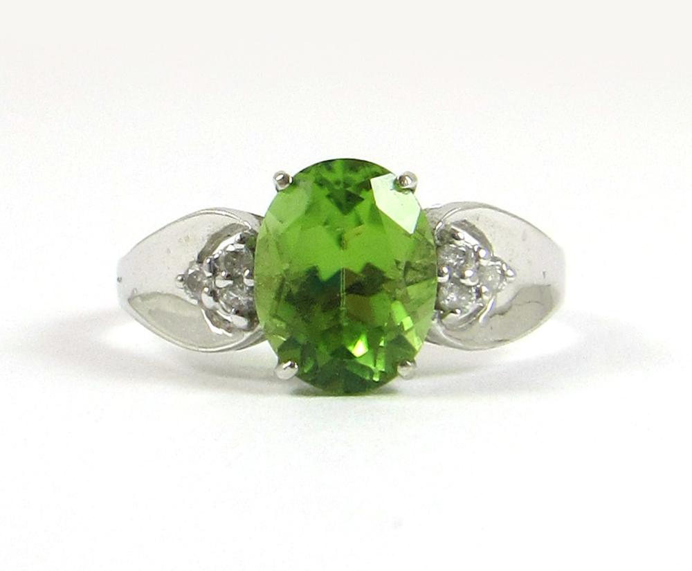 Appraisal: PERIDOT DIAMOND AND FOURTEEN KARAT WHITE GOLD RING with three