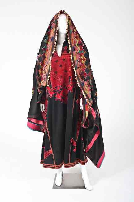 Appraisal: PALESTINIAN EMBROIDERED THOB AND VEIL The black thob with mostly