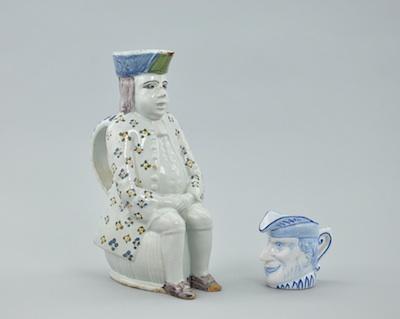 Appraisal: Two Faience Figural Pitchers The first a Toby form pitcher