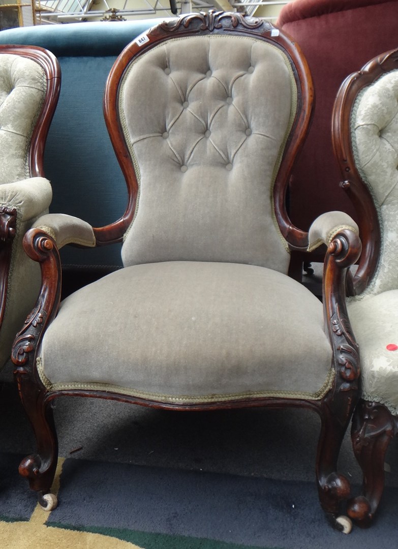 Appraisal: A Victorian walnut framed open armchair with serpentine seat on