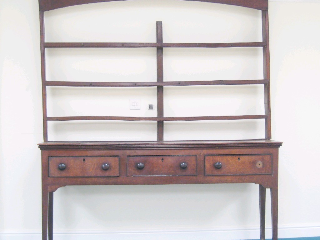 Appraisal: An antique oak Dresser with open rack the base fitted