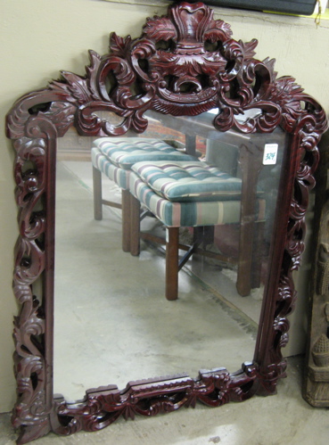 Appraisal: A PAIR OF WALL MIRROR in matching carved mahogany frames