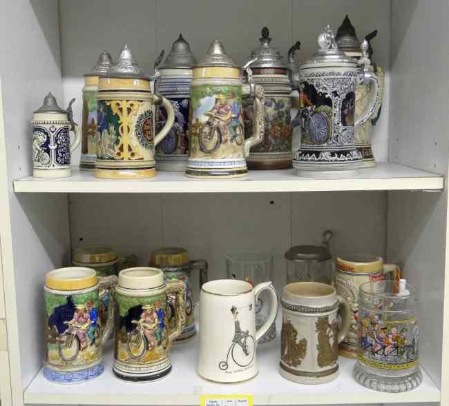 Appraisal: Bicycle stein lot pieces in porcelain glass and stoneware Good