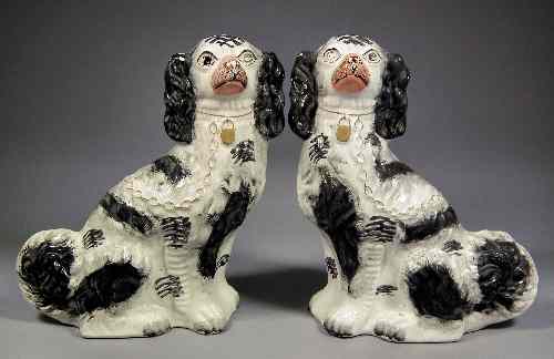 Appraisal: A pair of th Century Staffordshire pottery seated models of