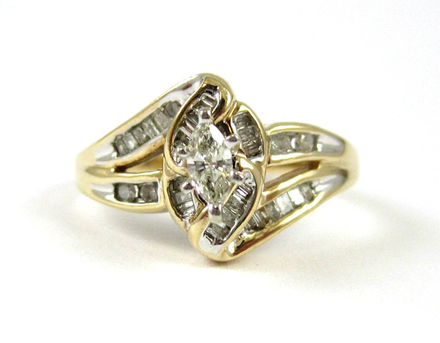 Appraisal: DIAMOND AND TEN KARAT GOLD RING with round-cut and baguette-cut