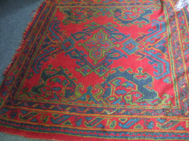 Appraisal: A Turkish rug the red field with a bold central