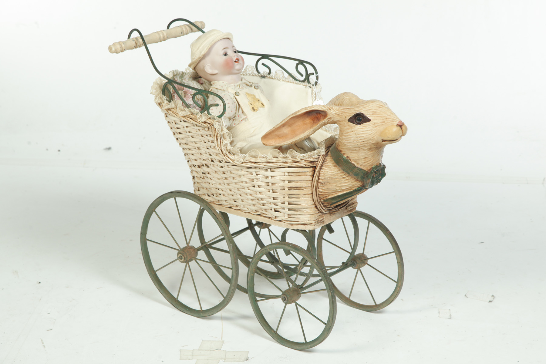 Appraisal: BISQUE HEAD DOLL AND A RABBIT CARRIAGE Germany th century