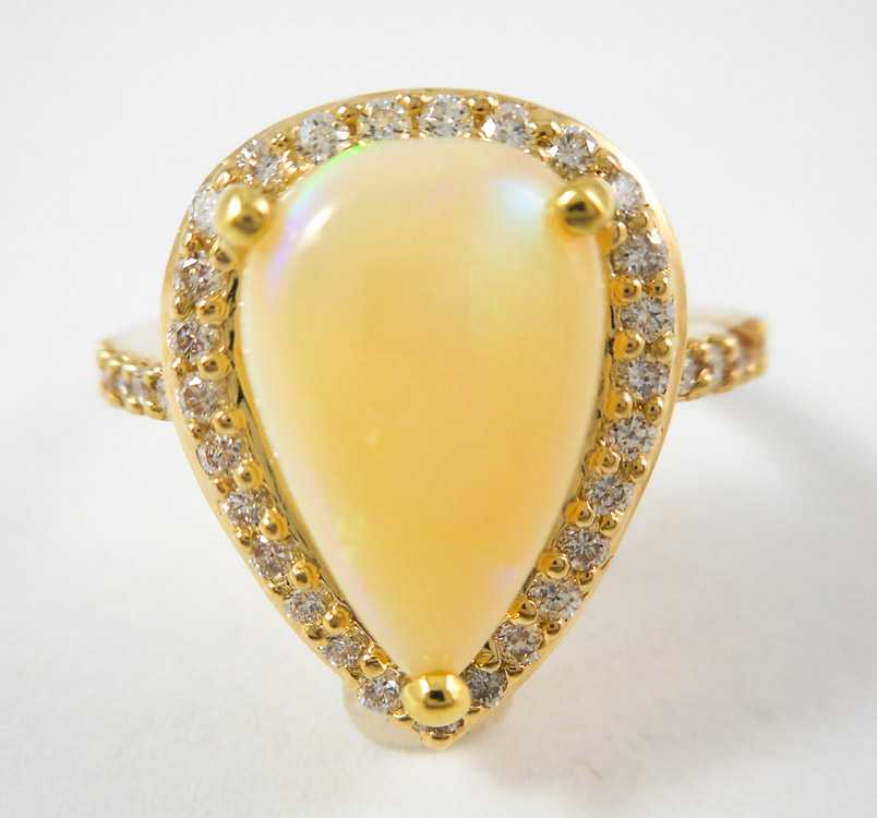 Appraisal: OPAL DIAMOND AND FOURTEEN KARAT GOLD RING with round-cut diamonds