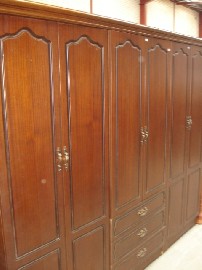 Appraisal: A th century six door wardrobe in timber veneer