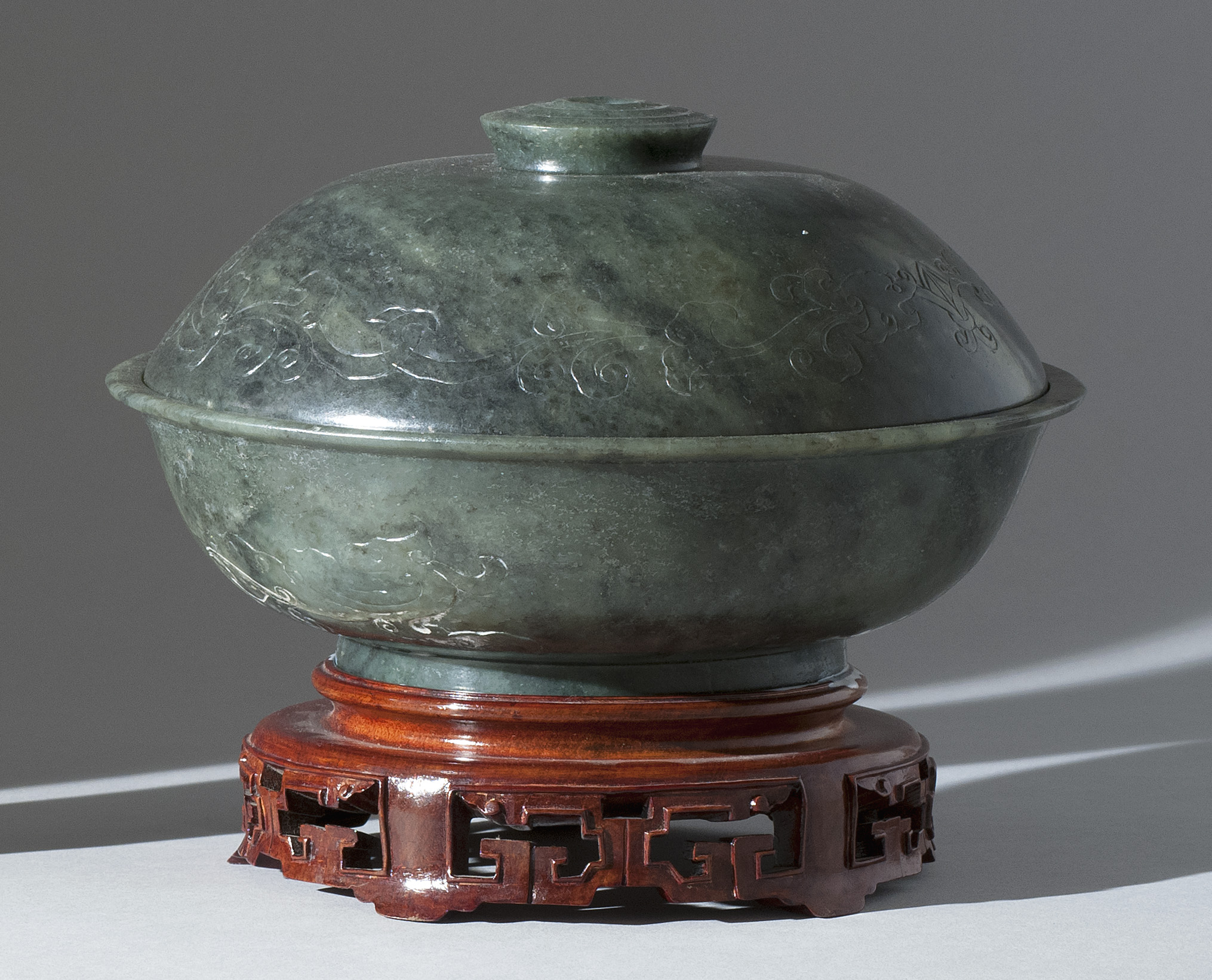 Appraisal: SPINACH-GREEN JADE COVERED BOWL Circa With engraved dragon design Domed