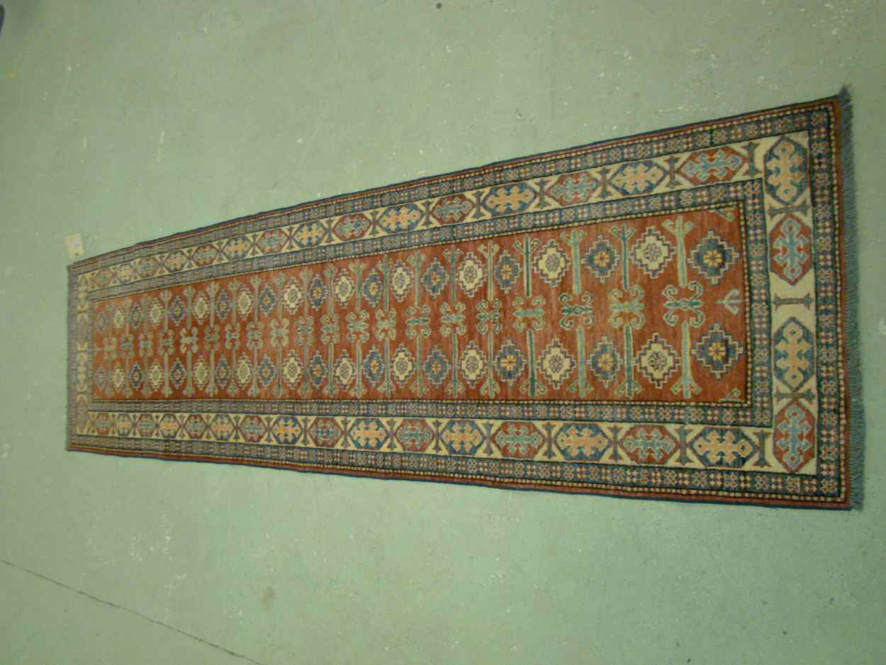 Appraisal: ORIENTAL RUG KAZAK-DESIGN RUNNER ' x ' Two rows of