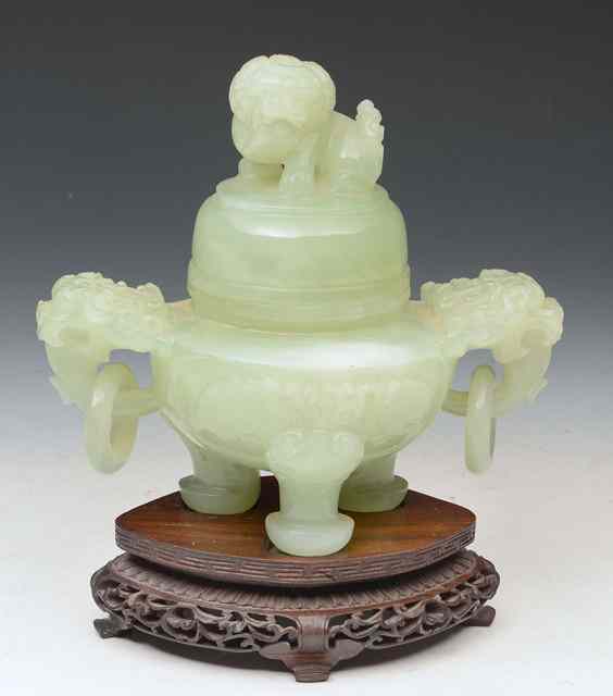 Appraisal: A CHINESE GREEN JADE KORO AND COVER with lion mask