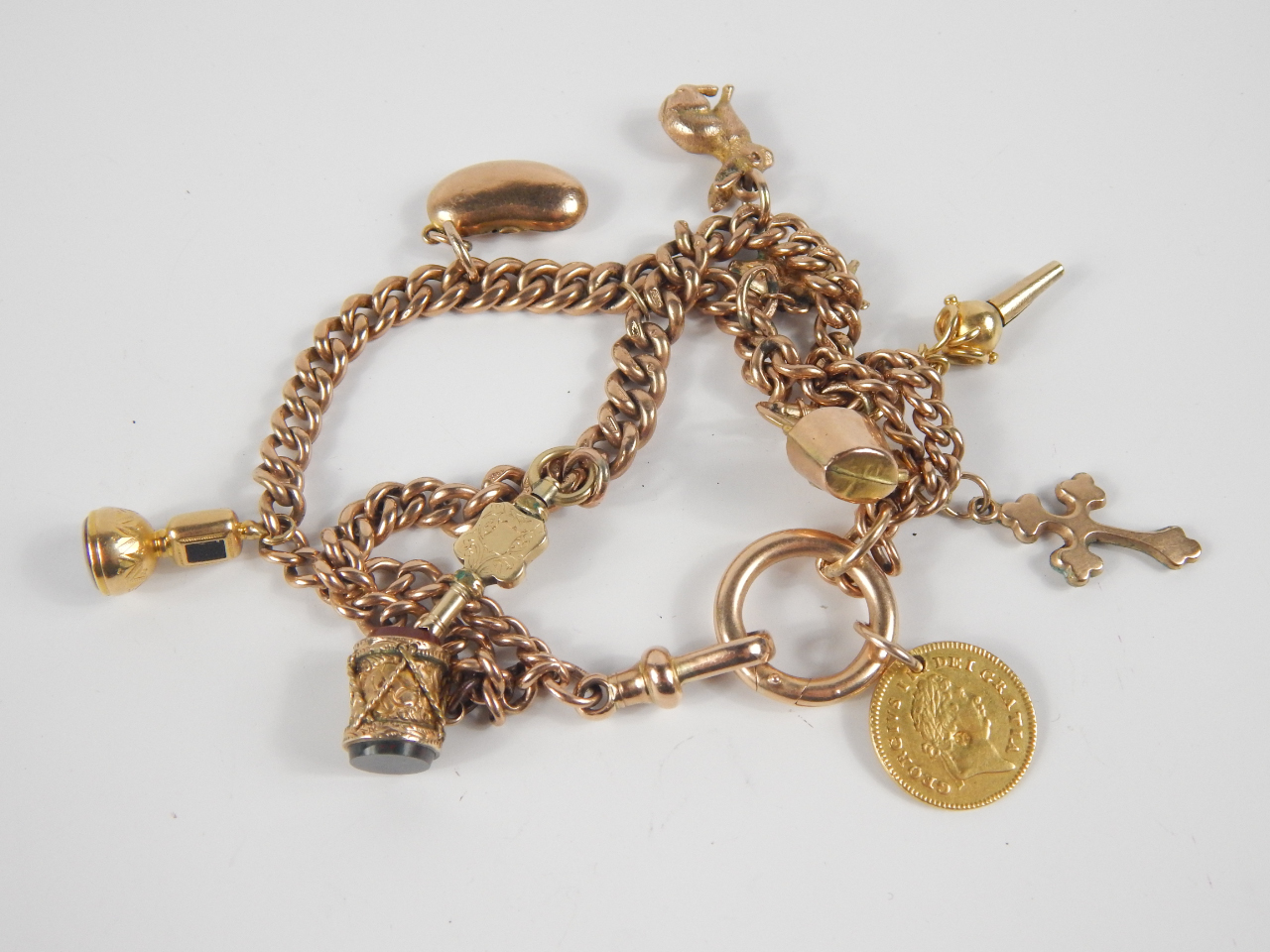 Appraisal: A ct gold charm bracelet with a George III Third