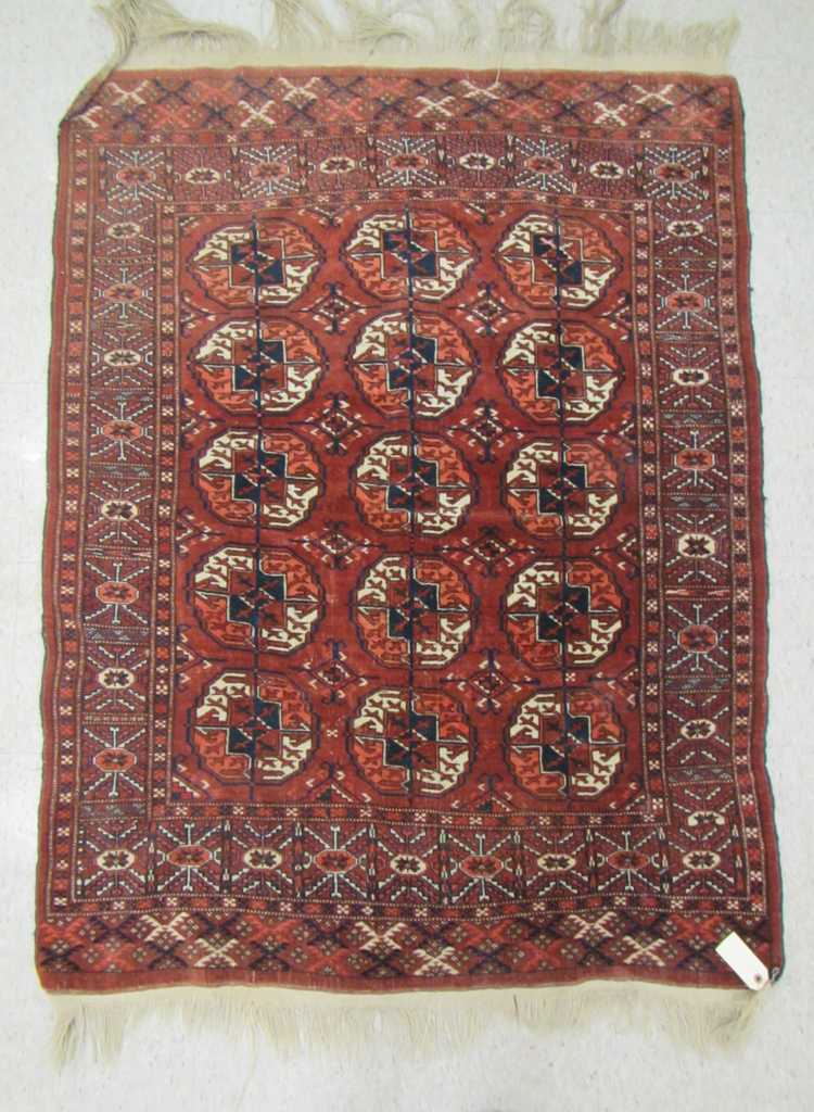 Appraisal: SEMI-ANTIQUE TURKOMAN BOKHARA AREA RUG featuring three columns of five