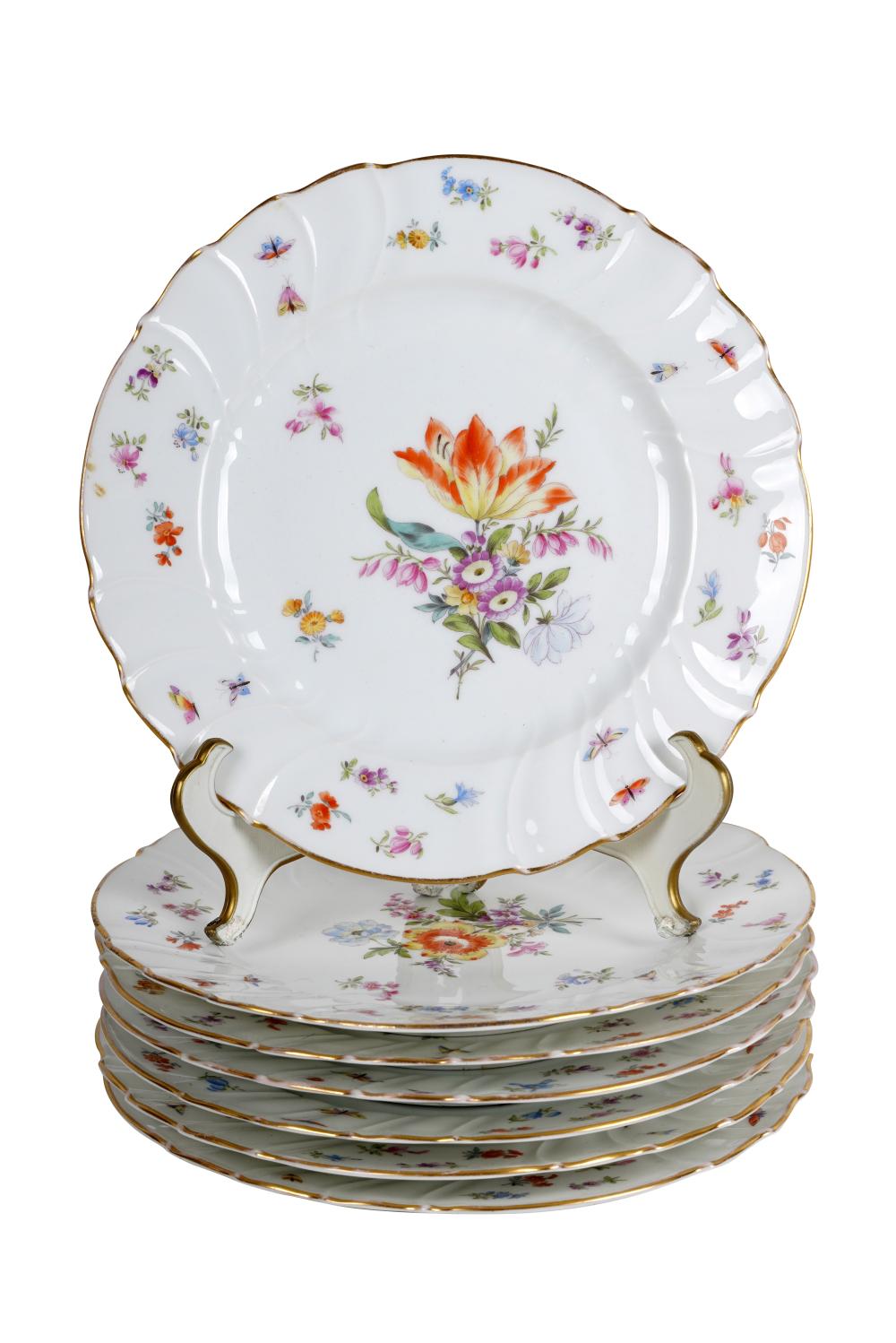 Appraisal: SEVEN PORCELAIN FLORAL LUNCHEON PLATESCondition one with tight crack to