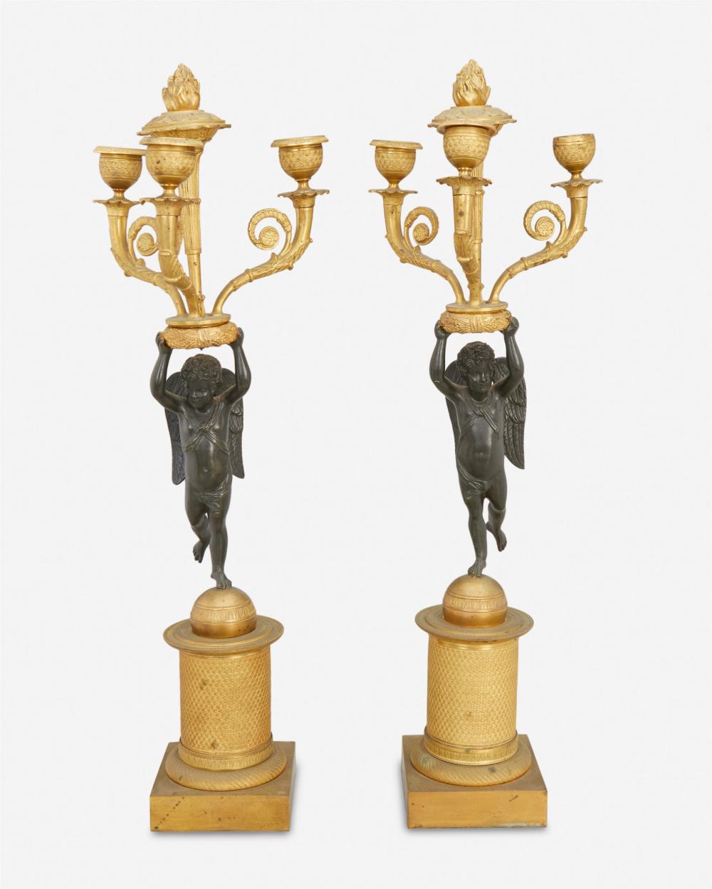 Appraisal: A pair of French Empire-style bronze figural candelabra Mid- th