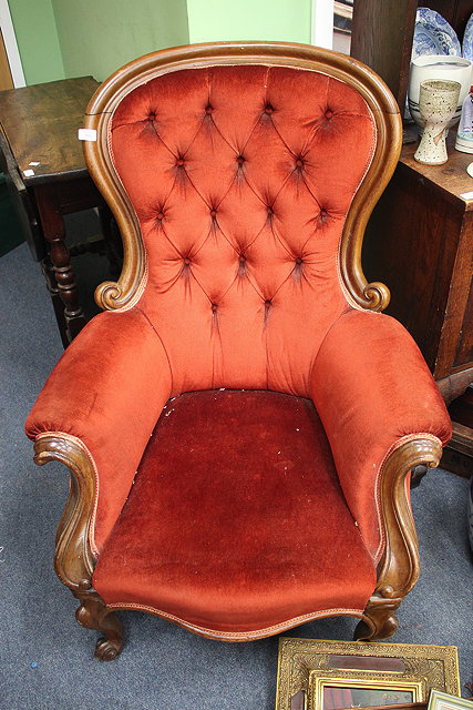 Appraisal: A VICTORIAN MAHOGANY ARMCHAIR with shaped button upholstered back overstuffed