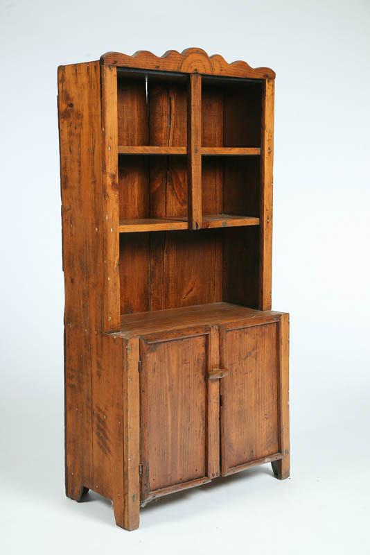 Appraisal: CHILD'S CABINET Red stained pine with a shaped crest two