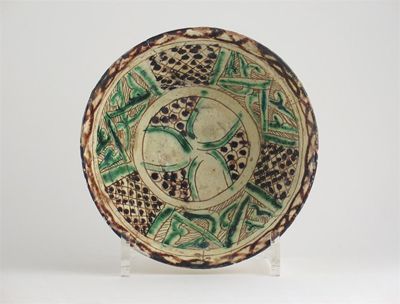 Appraisal: A Persian conical bowl decorated with geometric patterns in green