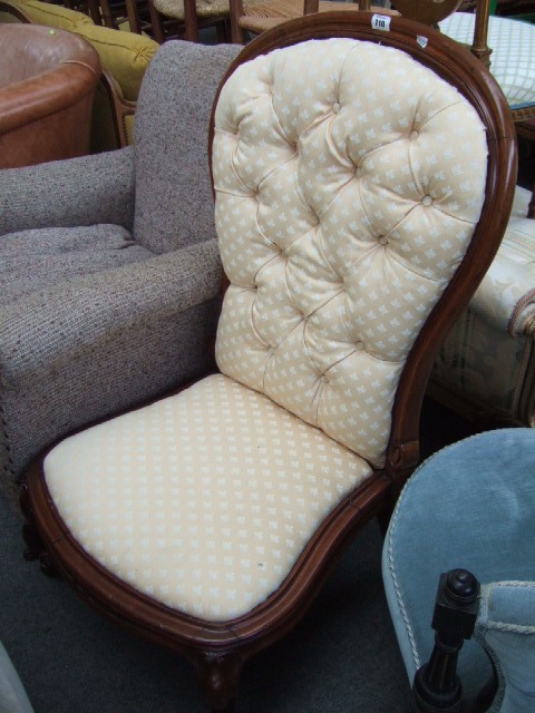 Appraisal: A Victorian walnut framed nursing chair with button upholstered back