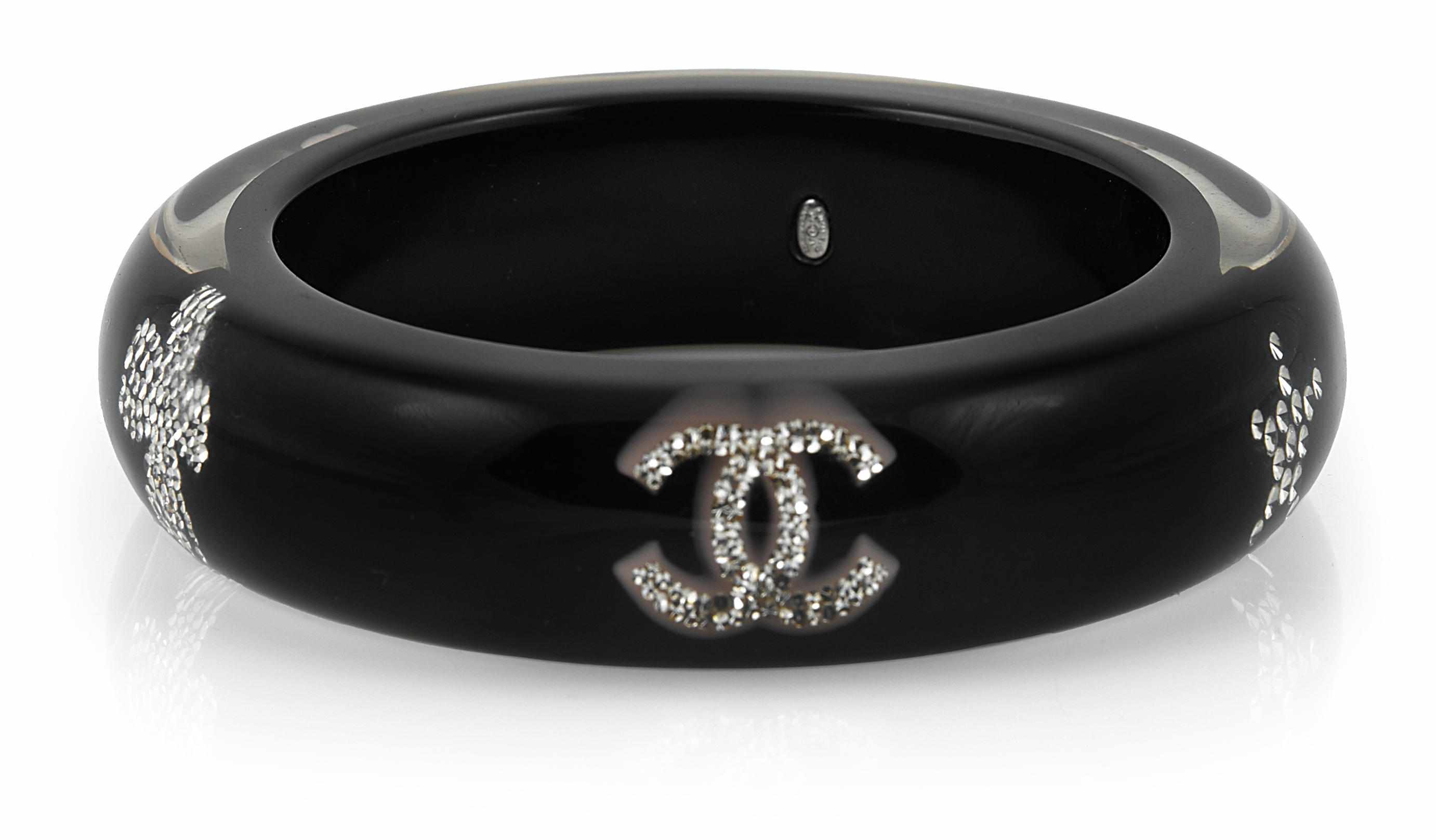 Appraisal: A Chanel plastic and rhinestone bangle bracelet with four leaf