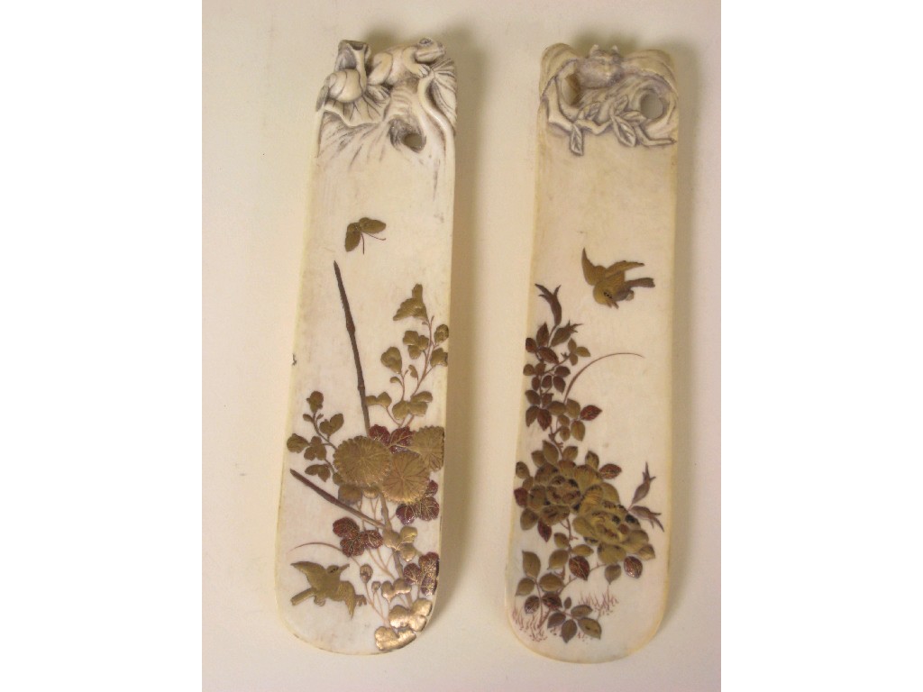 Appraisal: A Pair of Oriental ivory Shoe Horns with carved terminals