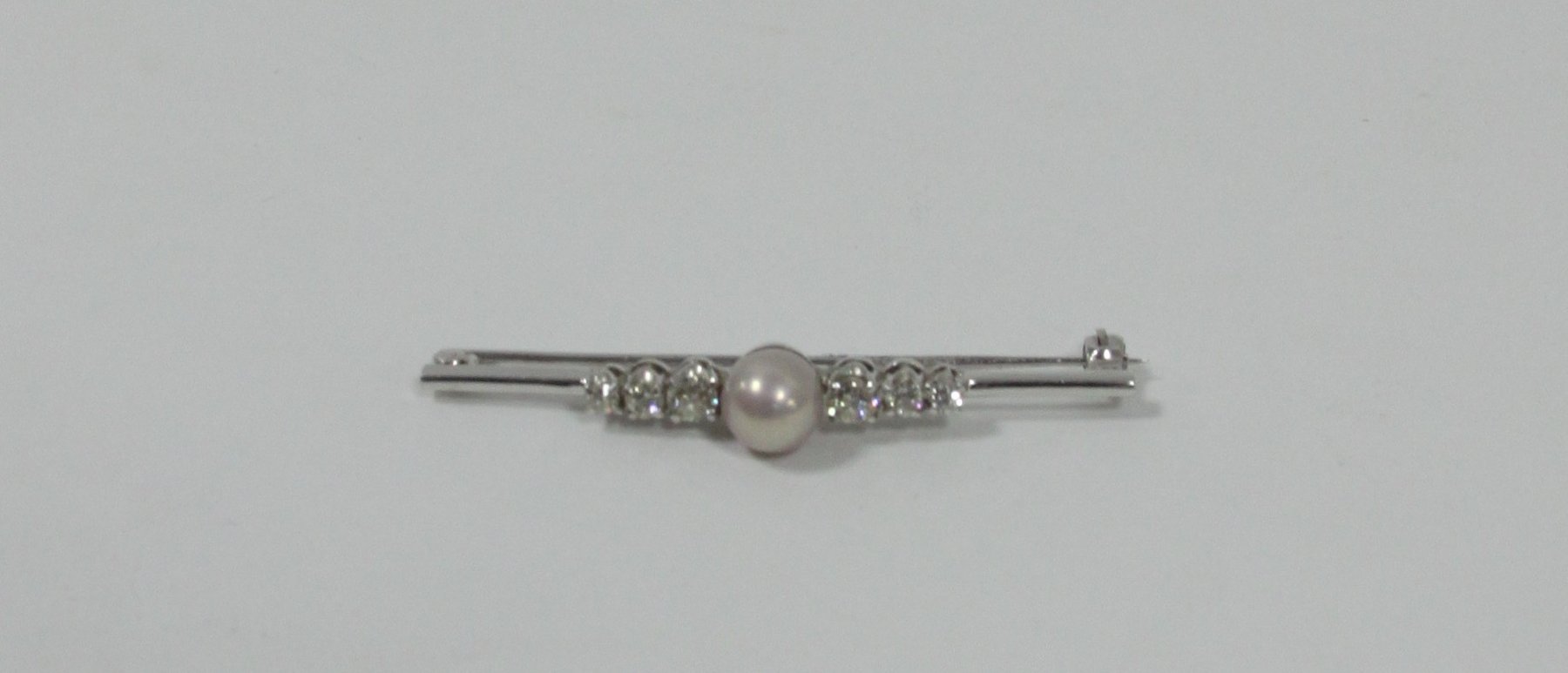 Appraisal: A pearl and diamond bar brooch the central pearl flanked