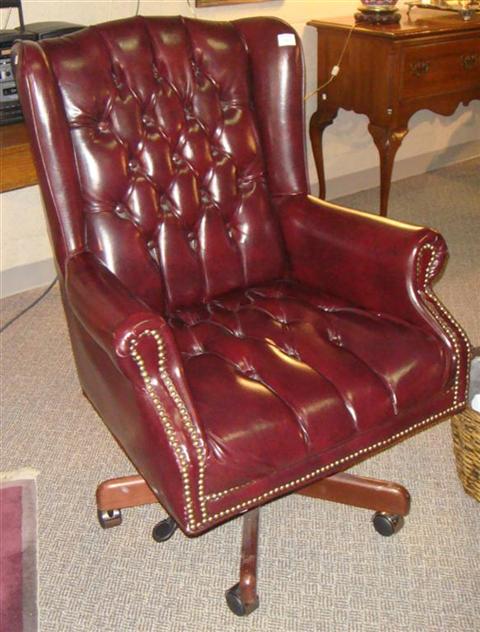 Appraisal: DARK RED LEATHER OFFICE CHAIR ON CASTERS The tufted leather