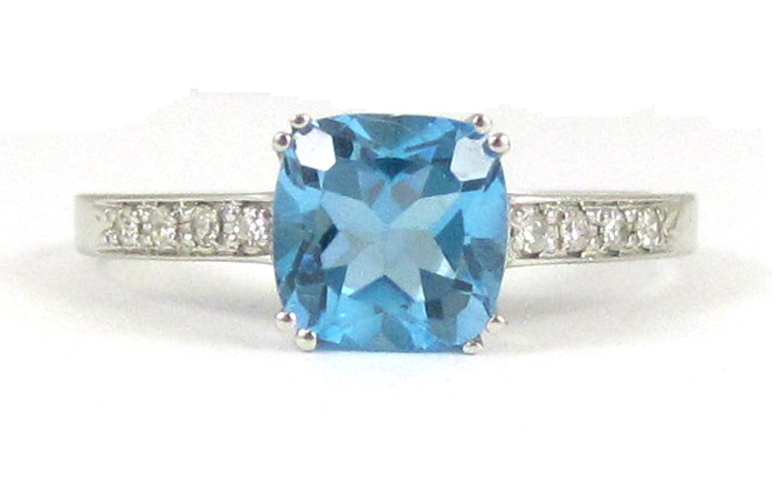 Appraisal: BLUE TOPAZ AND FOURTEEN KARAT WHITE GOLD RING with four