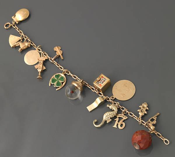 Appraisal: A gold charm bracelet with small charms g gross