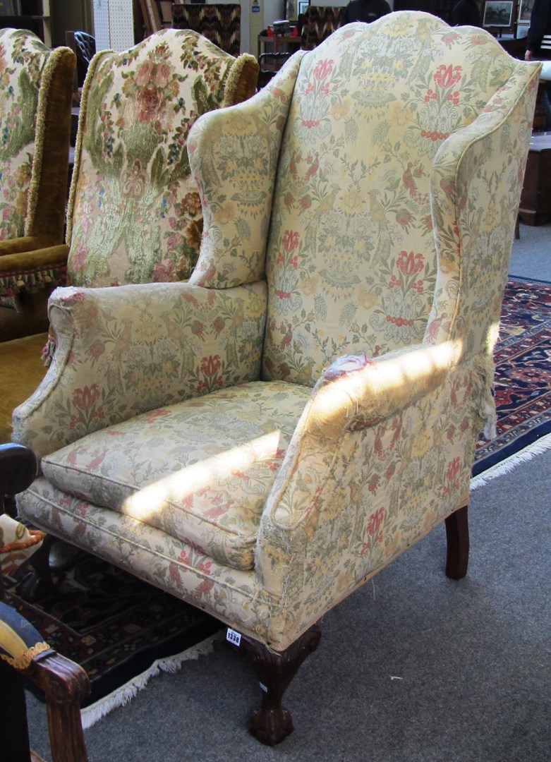 Appraisal: An th century design wingback armchair on mahogany claw and