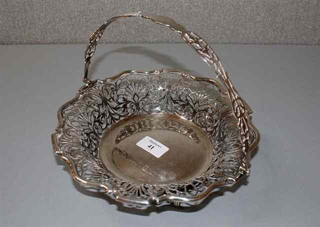 Appraisal: A GEORGE V SILVER CAKE BASKET with shaped edge and