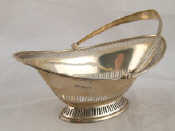 Appraisal: A boat shaped silver swing handled basket with pierced sides