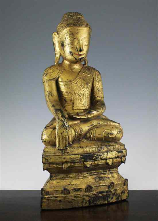 Appraisal: A Thai Indonesian giltwood and composite seated figure of Buddha