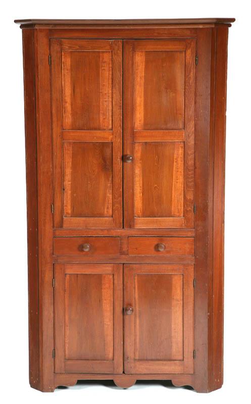 Appraisal: CORNER CUPBOARD Walnut having paneled blind top doors two drawers