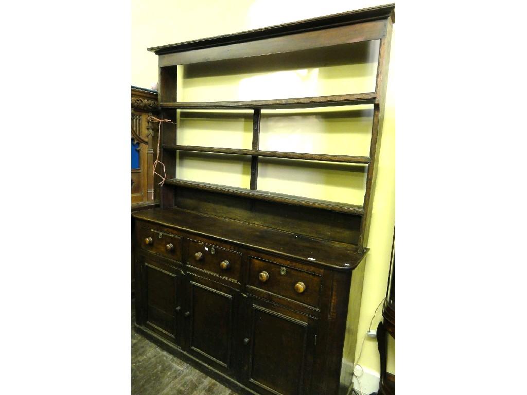 Appraisal: A th century oak dresser with rounded corners and fitted