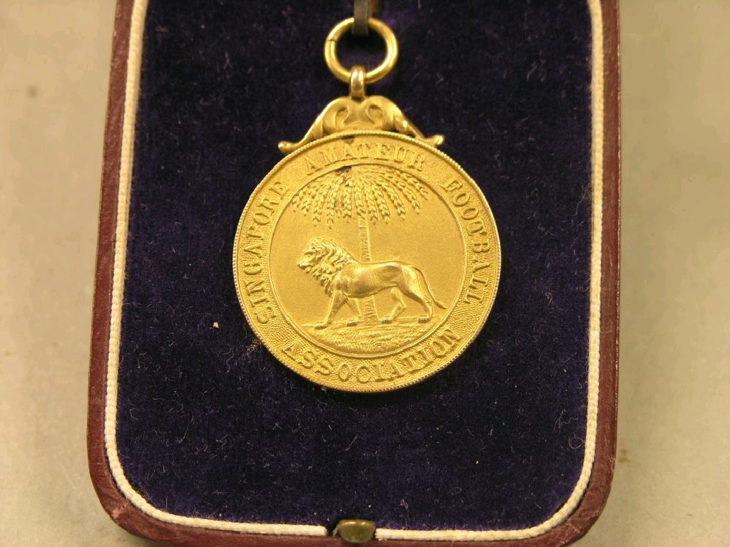 Appraisal: A ct gold football medal Singapore Amateur Football Association grams