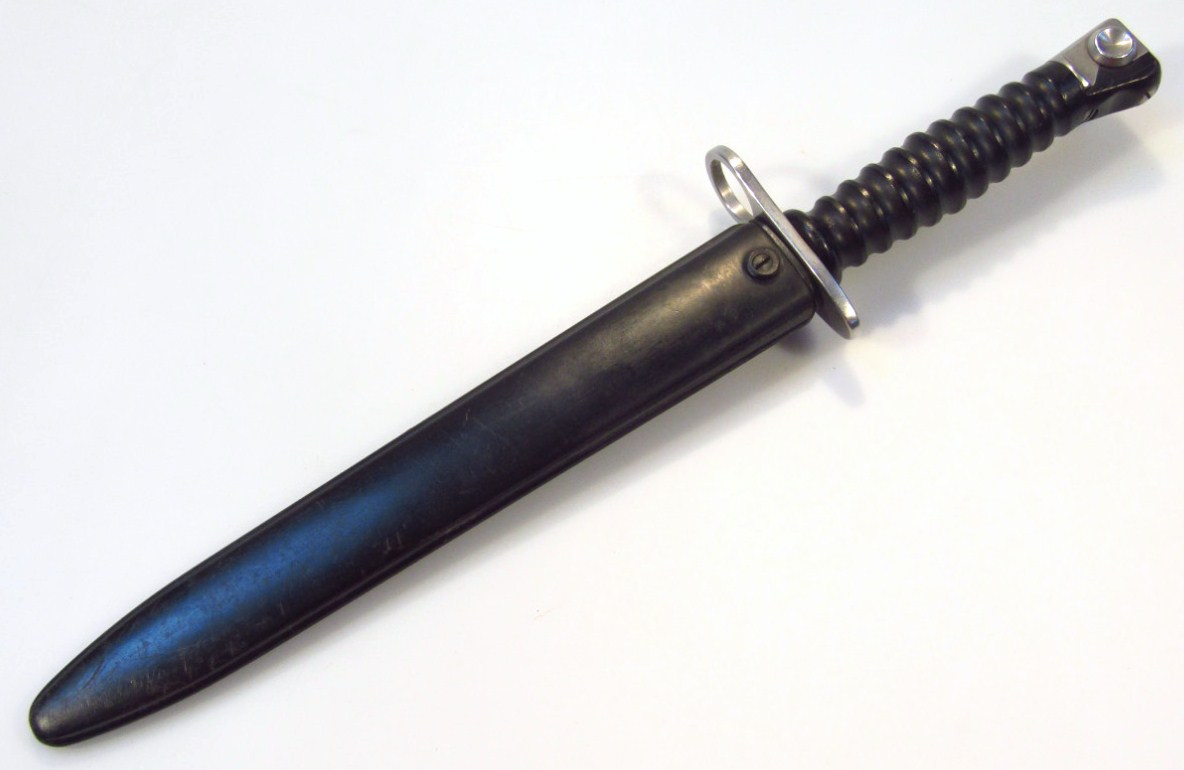 Appraisal: A thC F bayonet with pressed scabbard plain blade and