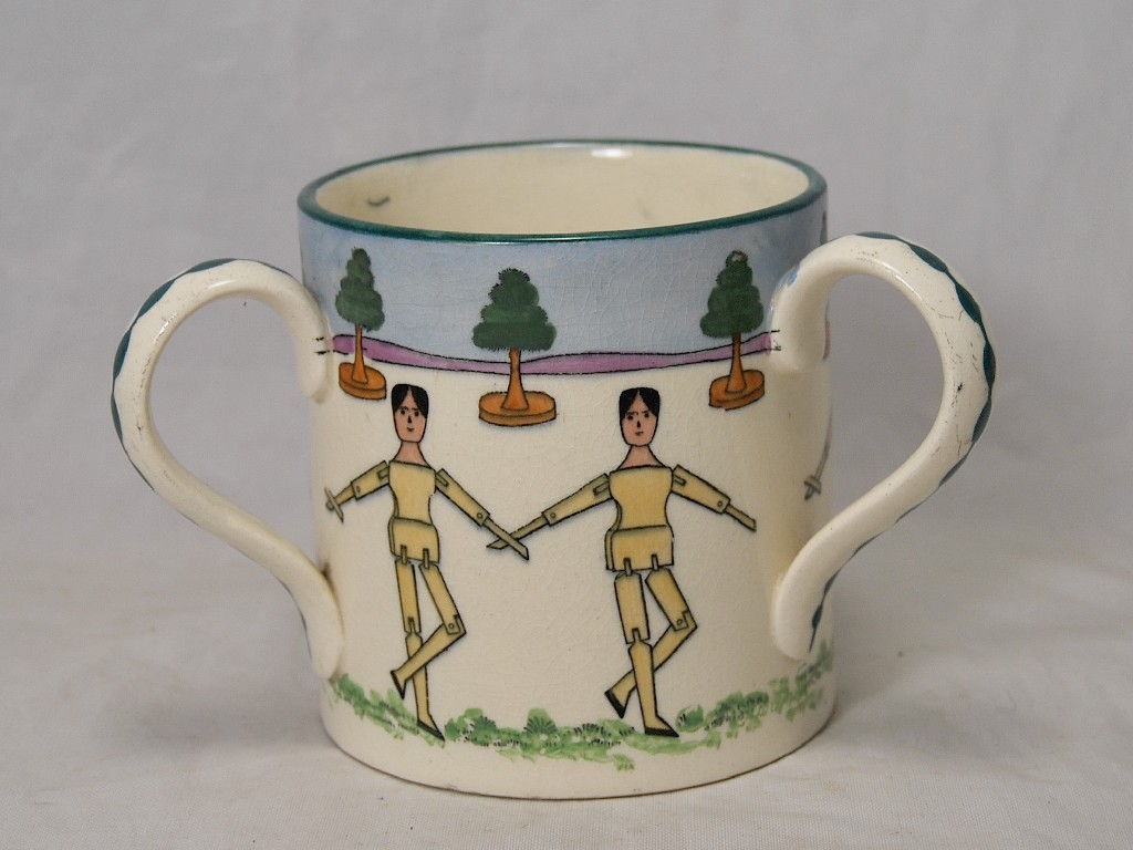 Appraisal: An Edwardian pottery three-handled loving cup printed with dancing dolls