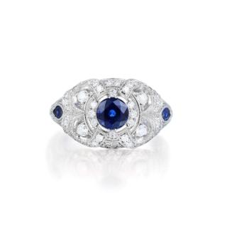 Appraisal: A Sapphire and Diamond Ring Featuring a centered round-cut sapphire